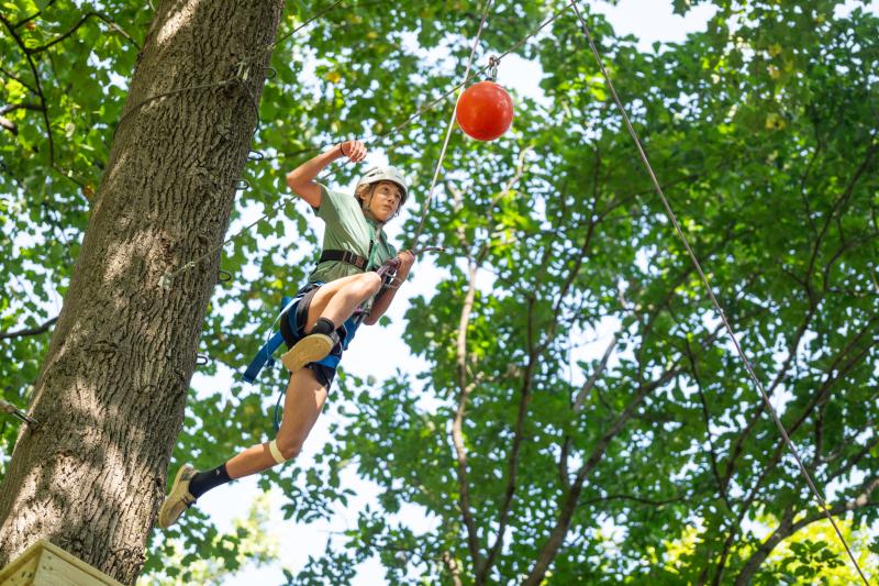 Freshman Henry Ennis launches himself from an elevated platform on the high ropes team-building course at Black Rock Retreat.